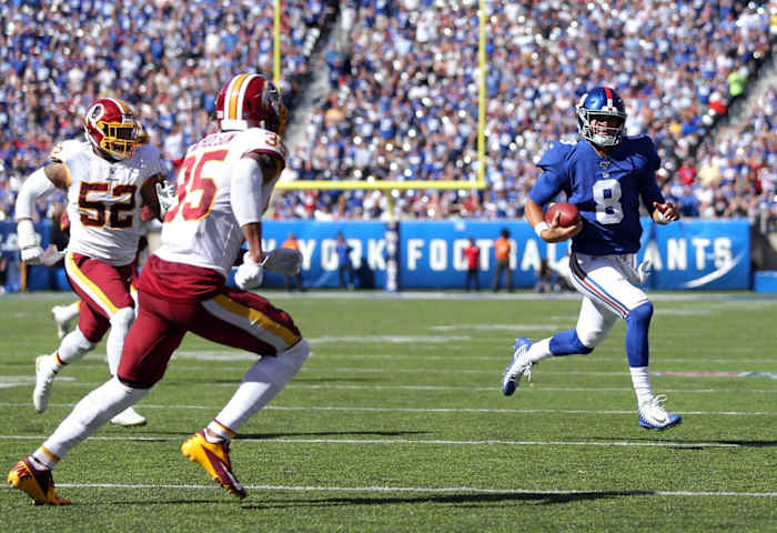 Sep 29, 2019; East Rutherford, NJ, USA; New York Giants quarterback Daniel Jones (8) runs the ball against Washington Redskins safety Montae Nicholson (35) and linebacker Ryan Anderson (52) during the second quarter at MetLife Stadium.